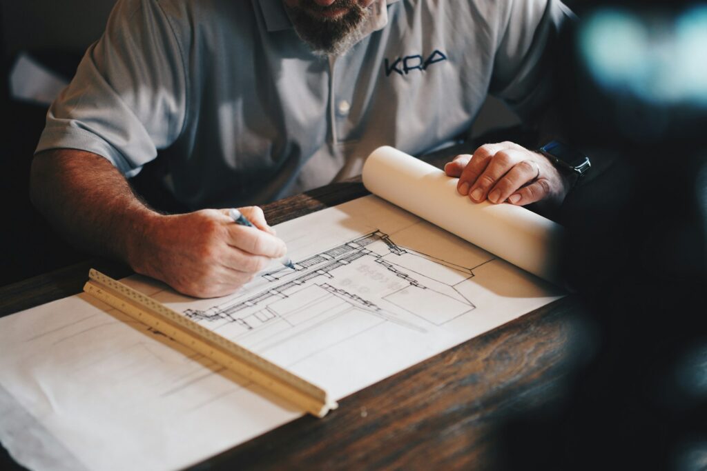 An engineer reviewing plans for a Biyout Aljewar project